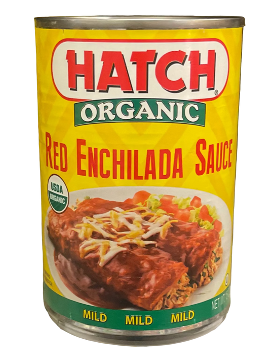 Can of Hatch Organic Red Enchilada Sauce on a grocery store shelf with other canned goods.